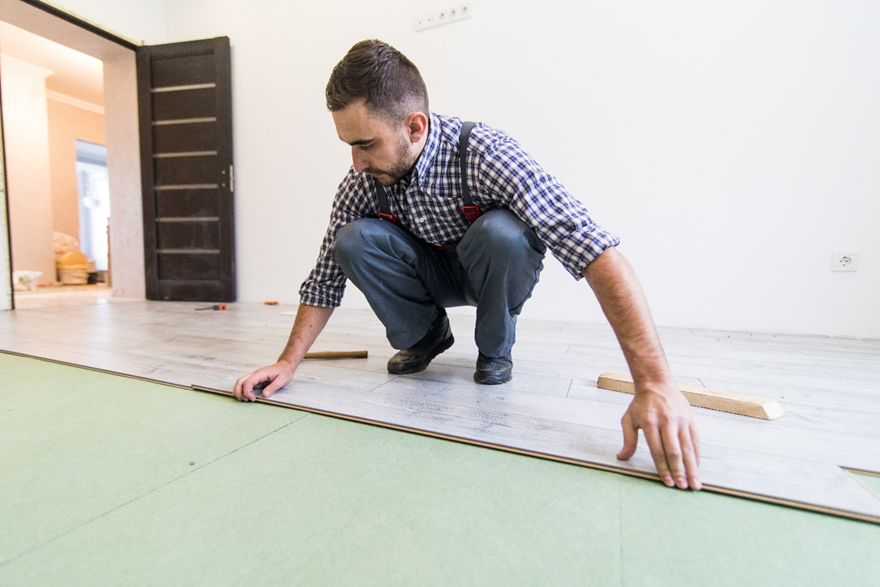 A Professional Who is Installing Laminate Flooring