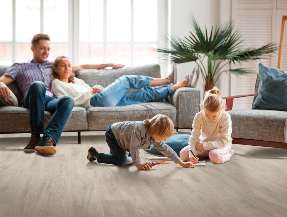Parents relaxing and watching kids playing on luxury vinyl tile flooring